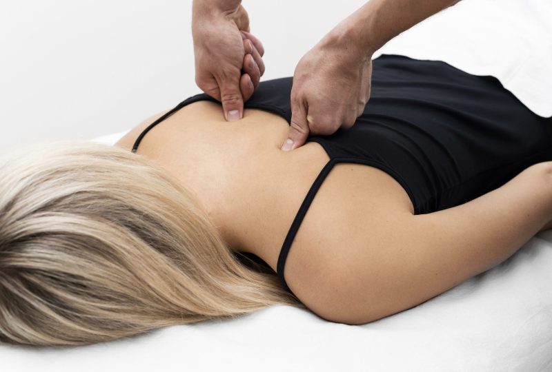 physiotherapist-performing-back-massage-female-patient